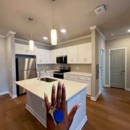 person holding keys in kitchen