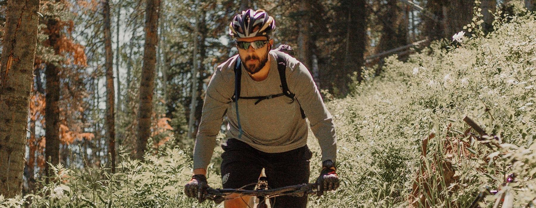 man riding a bike on a trail in the woods