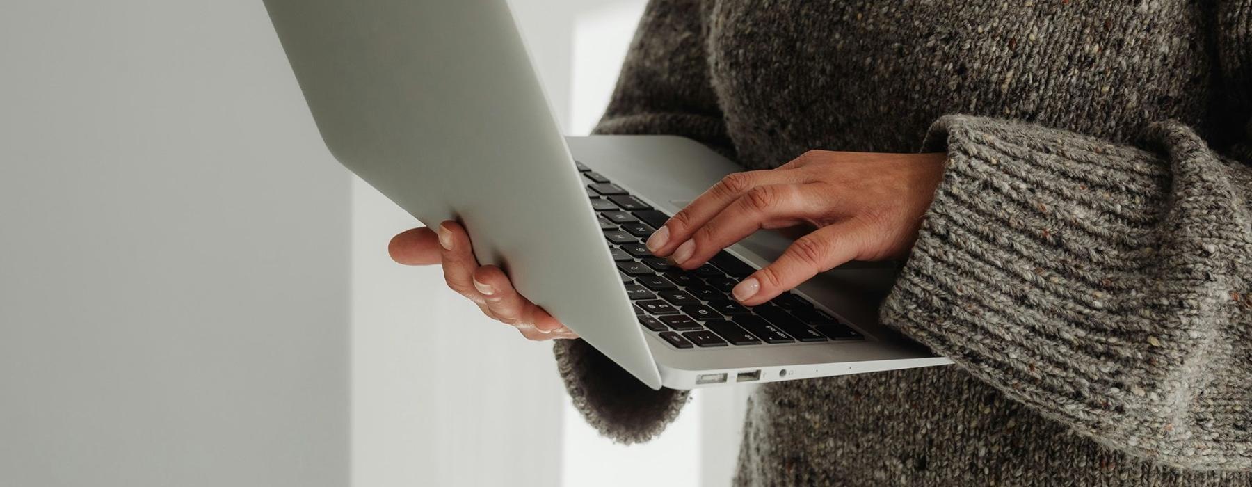 A person holding a laptop.