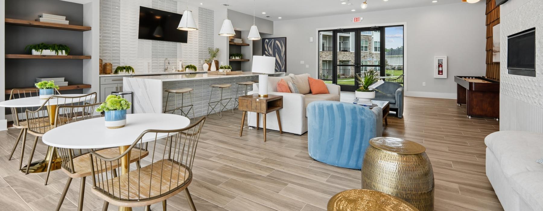 Residents of our new apartments in Columbia, SC enjoy a study lounge at The One at Columbia with a table, lounge chairs, and a couch.